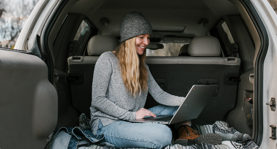 Women studying flashcards on her laptop in the woods